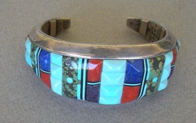   silver bracelet cuff with inlays of carved turquoise, coral, lapis